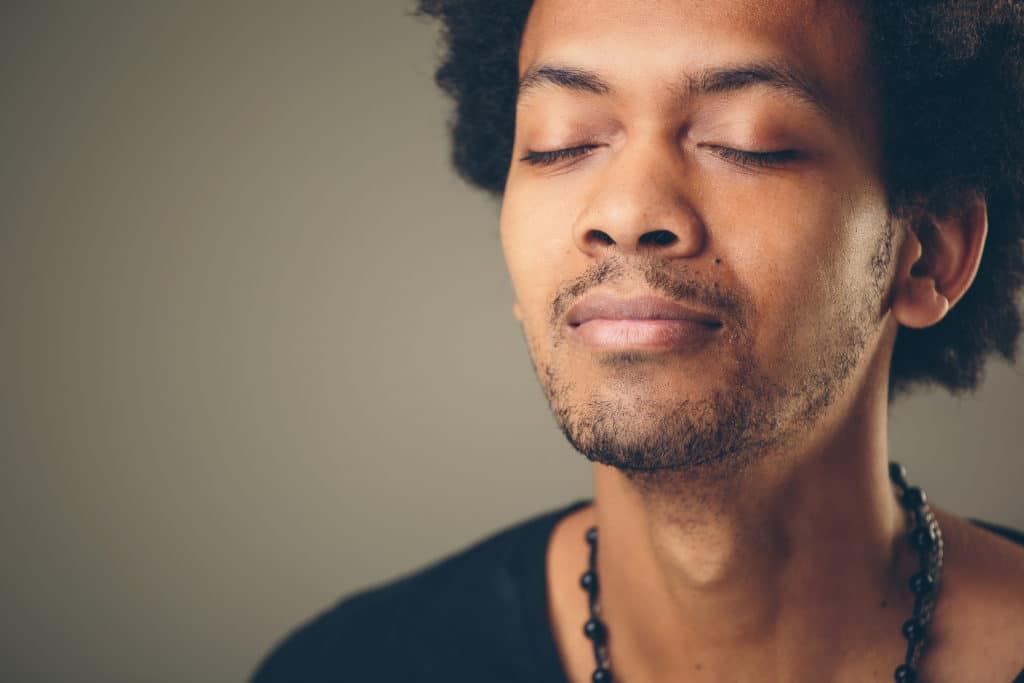 Man breathes deeply checks in with feelings