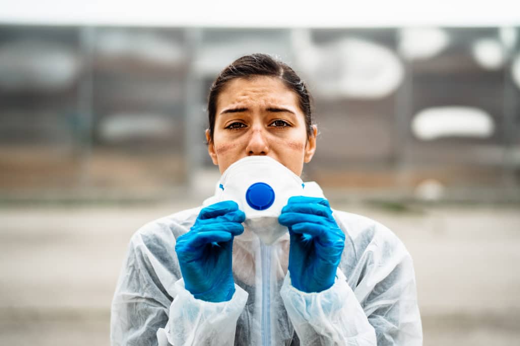 doctor looks upset while removing ppe